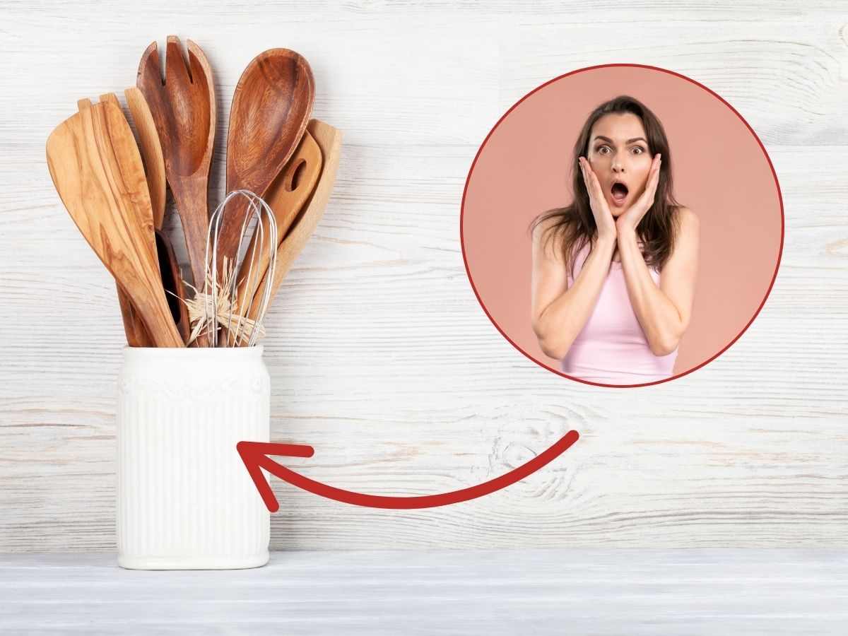donna preoccupata e utensili da cucina in legno